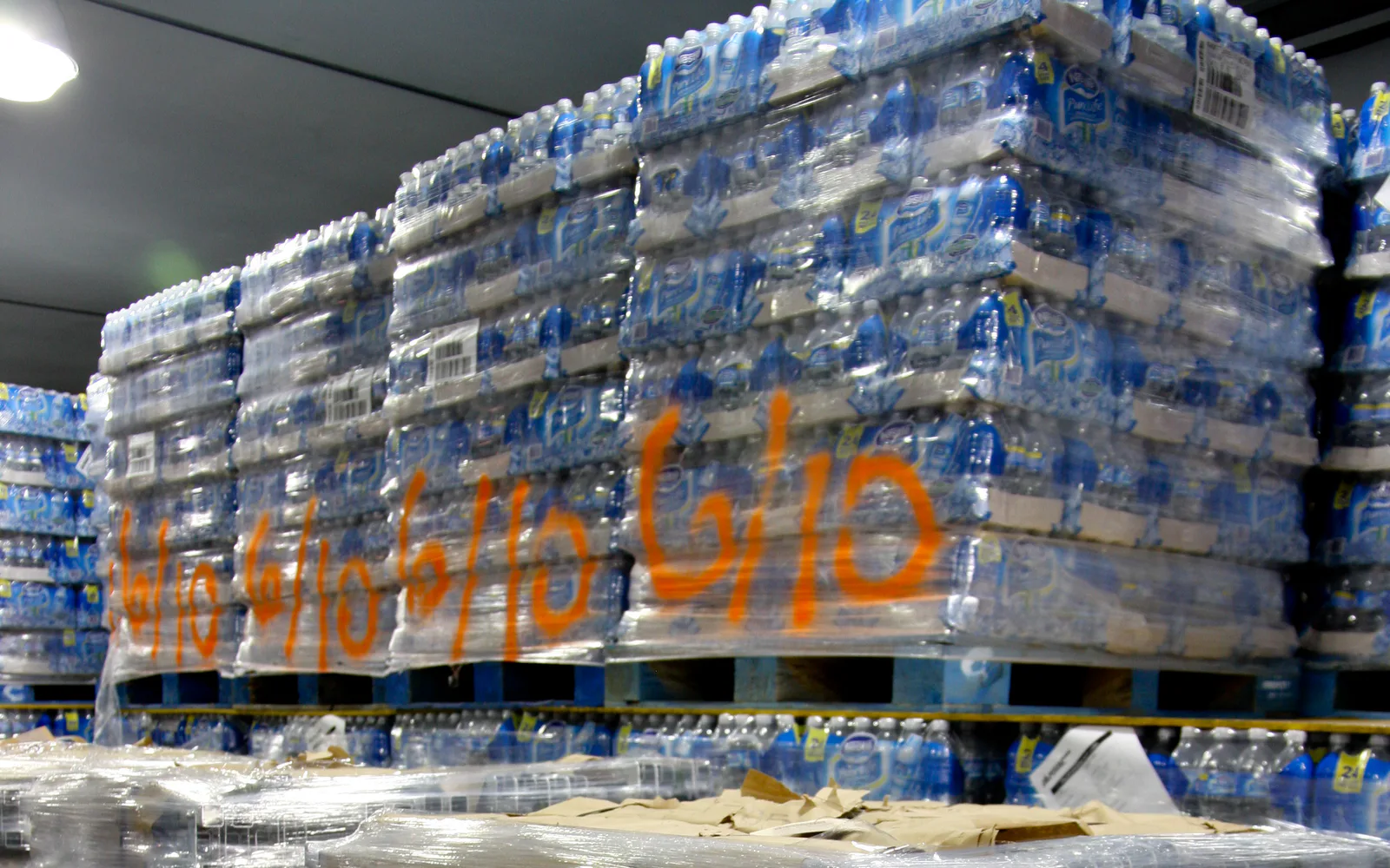 Pallets of emergency water staged in a disaster response warehouse